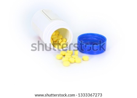 Tablets medicine pill are scattered on white background.