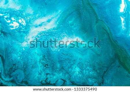 Abstract painting drawn by fluid acrylic technique. Picture with emerald, green, mint colorful water stains, gradients on blue background. Imitation of sea ocean waves on canvas. Modern art concept.