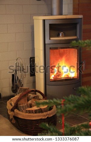 a fireplace with firewood and a fir tree