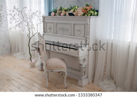 White vintage piano in a bright room
