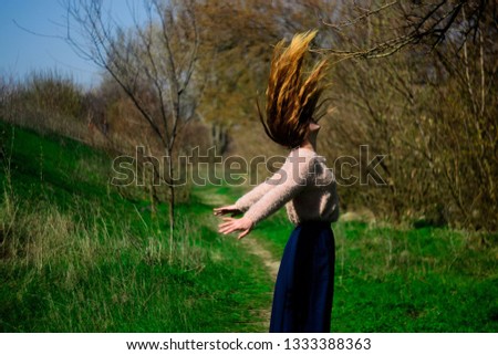 spring green grass and girl toss hair up