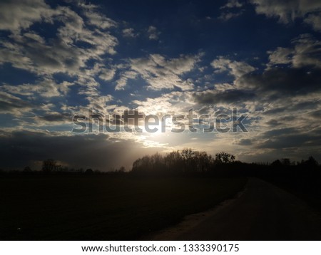 Brightly sun on the clouds sky background  Royalty-Free Stock Photo #1333390175
