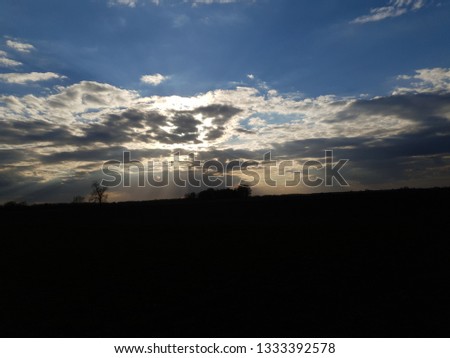 Cloudy sky with sun inside Royalty-Free Stock Photo #1333392578