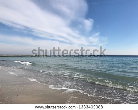 Sandy beach by the sea and beautiful sky