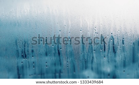 Dripping Condensation on the clear glass window. Water drops. Abstract background texture. Detail of moisture close up