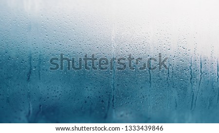 Detail of moisture condensation problems, hot water vapor condensed on the cold glass close up Royalty-Free Stock Photo #1333439846