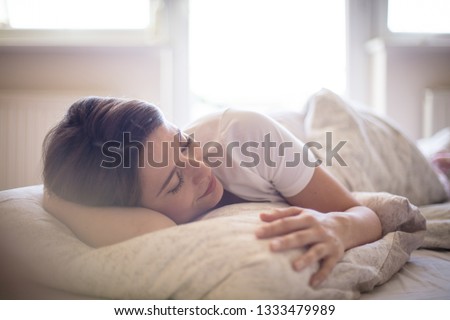 There's nothing better than a lie in. Woman sleeping in bed. Royalty-Free Stock Photo #1333479989