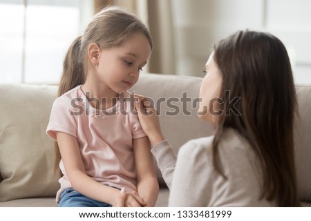 Loving worried mom psychologist consoling counseling talking to upset little child girl showing care give love support, single parent mother comforting sad small sullen kid daughter feeling offended Royalty-Free Stock Photo #1333481999