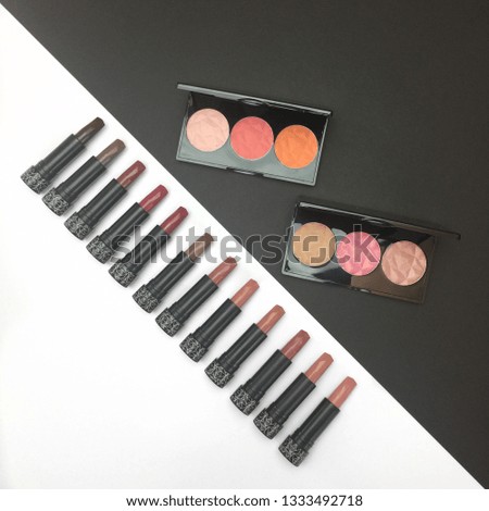 Beautiful Makeup Cosmetics with vivid colors lipsticks matte and gloss shades with brushes photography