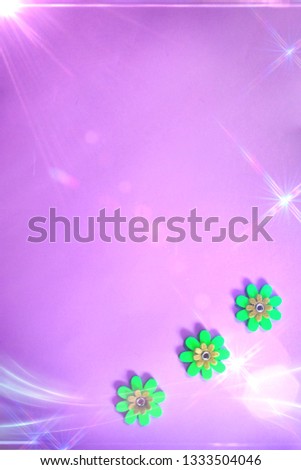 beautiful minimal bright colorful close up top view flat lay photo of small fake flowers on bright background with copy space and magical shiny  old school retro effects of light and bokeh 
