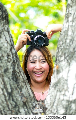 Portrait of female photographer retro camera on hand and Holding camera above the head