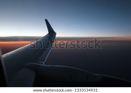 sunset picture from a inside of a plane