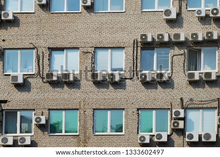 residential building facade. Lot of air conditioners attached to the wall