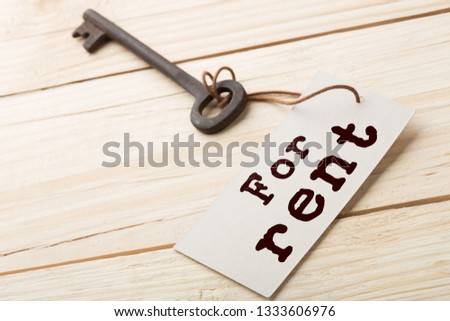 real estate rent concept - old key with tag