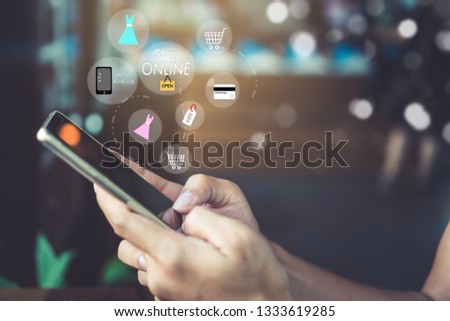 Women hand using smartphone do online selling for people shopping online in black friday with chat box, cart, dollar icons pop up. Social media maketing concept.