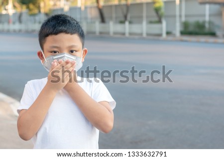 Kid boy wearing a protection mask against PM 2.5 air pollution Royalty-Free Stock Photo #1333632791