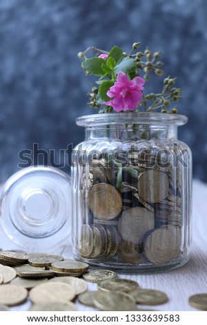 Concept of saving money, coins in a glass