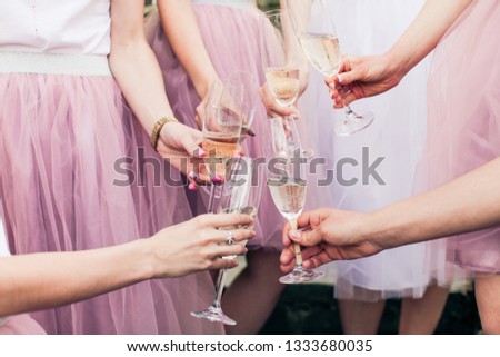 Close view of hands with glasses of champagne