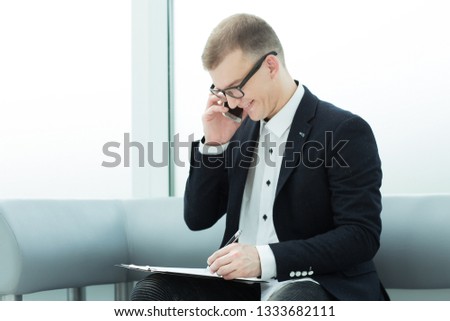 businessman discussing a business document on his smartphone