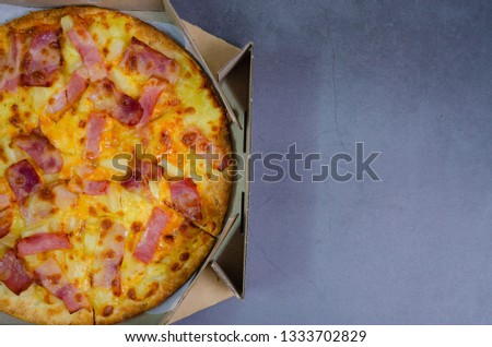 Delicious pizza sheets and ingredients for cooking ham and pineapple on a black background Top view of hot pepperoni pizza. With copy space for text. Flat lay Banner.