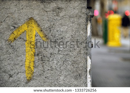 Yellow arrow painted on a wall