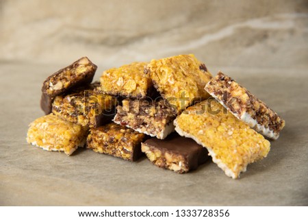 A variety of muesli and cereal bars. Different Energy protein bar on marble stone background. Set of energy, sport, breakfast and protein bars