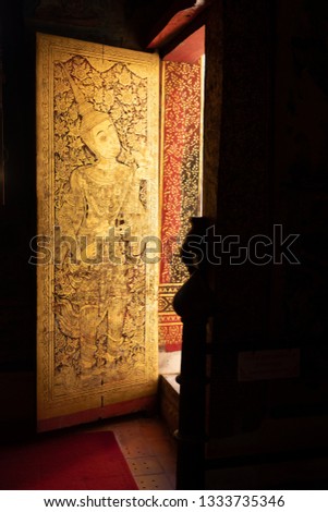 Golden and red Thai style temple window,