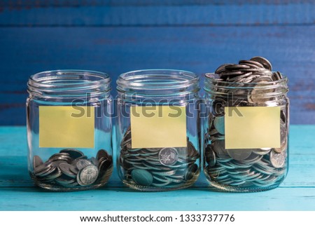 Jars of Malaysia Coins on a Blue Board