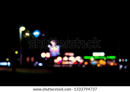 Defocused city lights in a darkness. Night road, city life. Colorful bokeh lights.