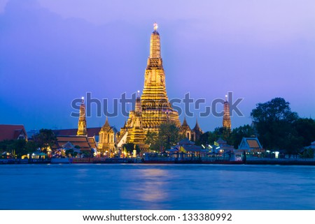 Wat Arun, The Temple of Dawn, at twilight, view across  Chao Phraya river. Bangkok, Thailand.
