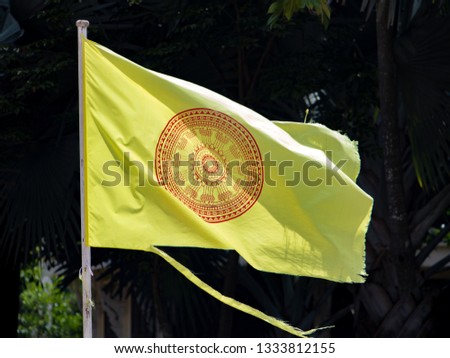 The dhammacakka flag, the symbol of Buddhism in Thailand flying in wind.