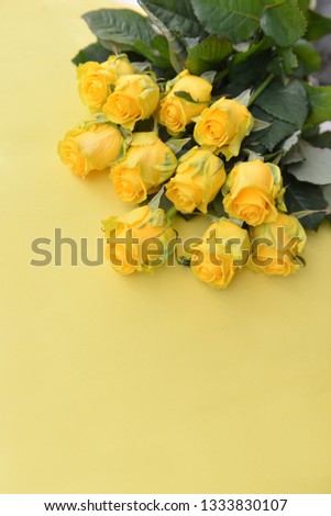 A bouquet of fresh yellow roses flowers with leaves on an isolated background. Flat lay, top view. corner composition. postcard birthday floral arrangement