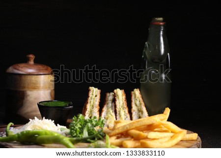 Club-sandwich with french fries and other fast food