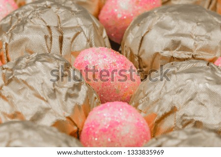Easter theme picture featuring colorful small Easter eggs and foil wrapped chocolate