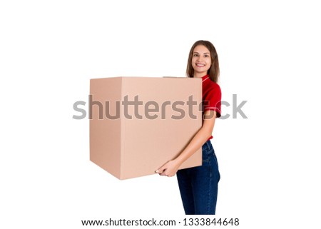 Friendly young delivey girl brings a big parcel for a customer isolated on white background.
