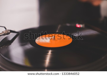 A vinyl turning on a console in a vinyl shop.