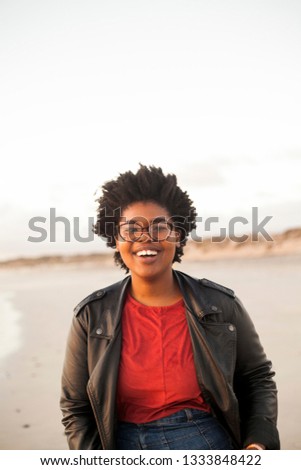 Portrait photography session of a young African woman at a Cape Town beach during sunset.