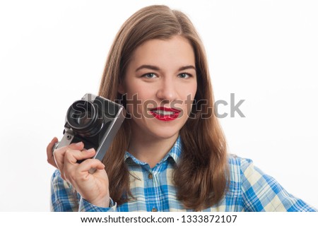 Portrait of young charming positive woman photographer with camera in casual clothes on white background