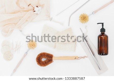zero waste home. Brushes for washing dishes, metal straws, glass soap dispenser, luffa, eco friendly flat lay. sustainable lifestyle concept. plastic free items. reuse, reduce