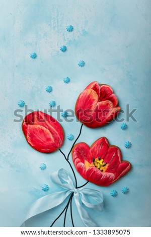 red gingerbread in the shape of flowers on a blue background