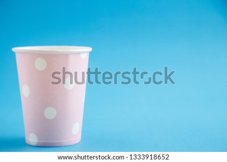 Cardboard disposable cups isolated on a blue background. Front view