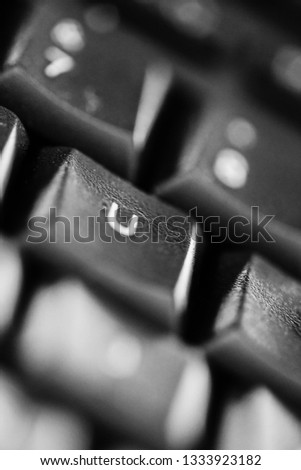 Black and white photograpy of a close up computer keys with letters from a pc keyboard in macro style. Suitable as a background wallpaper or texture