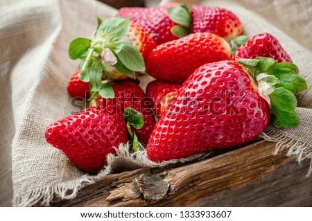 Beautiful ripe strawberries for sale on a tray in wooden containers. without plastic