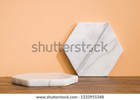 Polygonal marble background material on orange background wooden floor