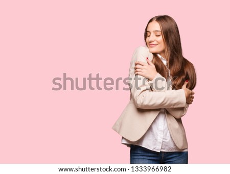 Young caucasian business woman giving a hug