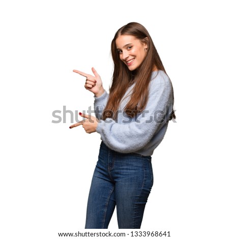 Young caucasian woman pointing to the side with finger