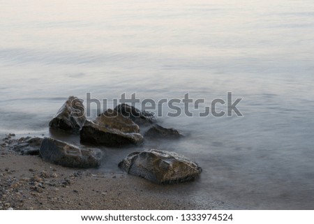 group of rocks with water hitting them