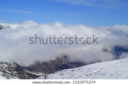 Mountain peaks over clouds. Landscape in Grandvalira ski area, Andorra.