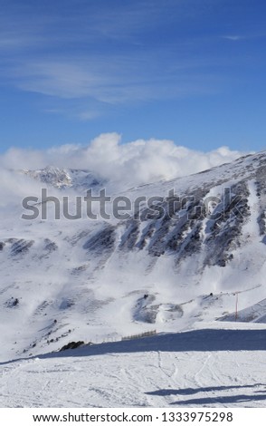 Mountain peaks over clouds. Landscape in Grandvalira ski area, Andorra.