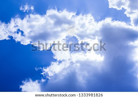 white clouds making heart shape in a blue bright sky